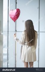 stock-photo-woman-with-back-to-camera-holding-heart-shaped-balloon-571978117.jpg