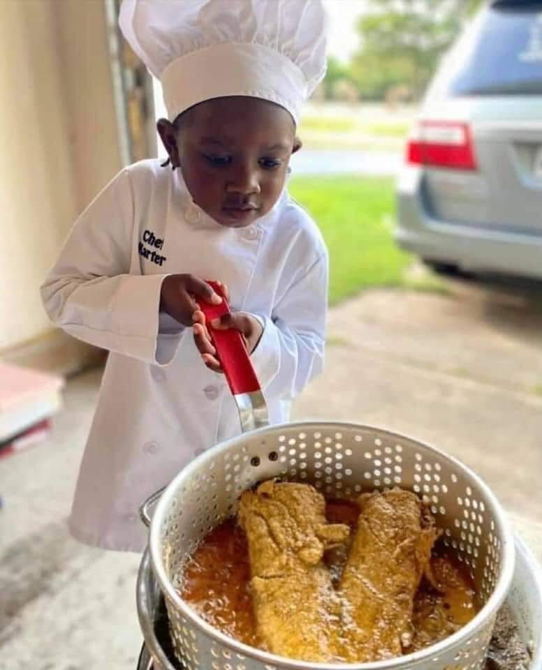 Little boy frying fish..jpg